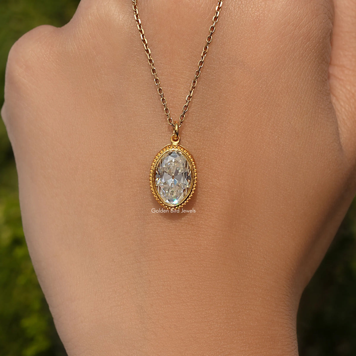 In hand Showing View Of Old Mine Oval Moissanite Pendant