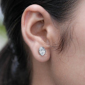 In Ear View of Bezel Set Oval Cut Lab Diamond Stud Earrings