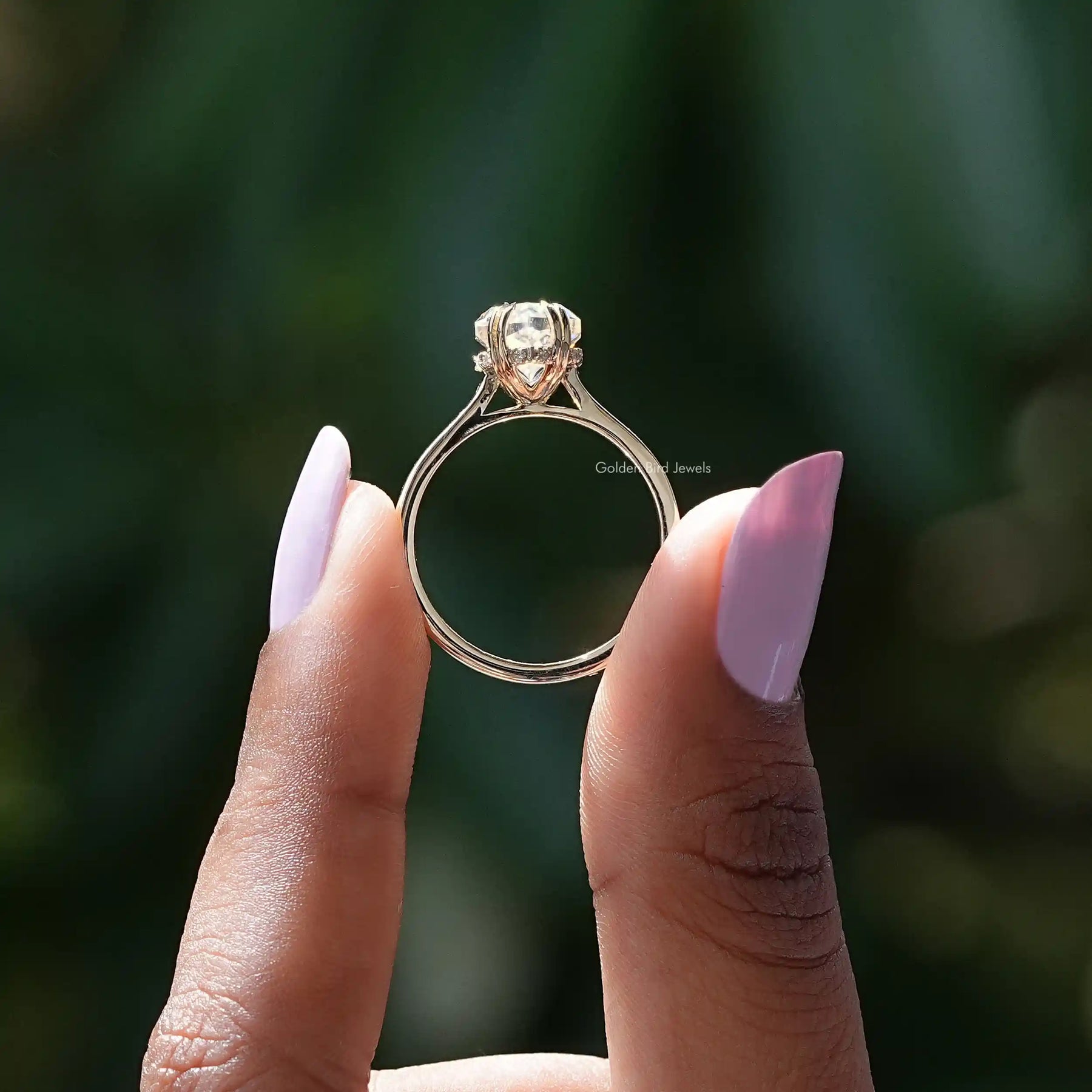 Back View of Marquise Cut Moissanite Halo Engagement Ring In two fingers