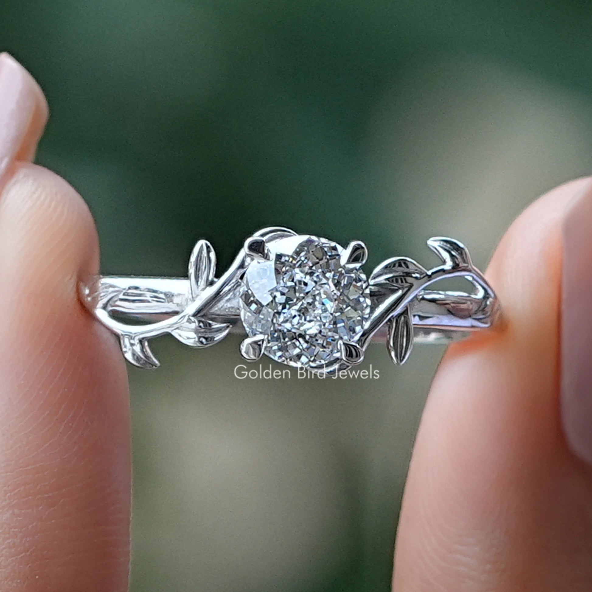 Portuguese Cut Round Diamond Engagement Ring Held Between Fingers