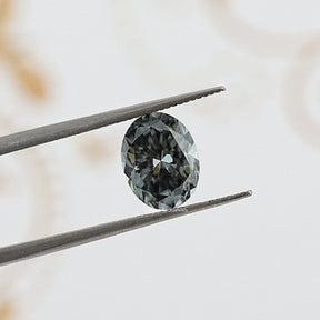 tweezers  View of Gray Oval Cut Moissanite 