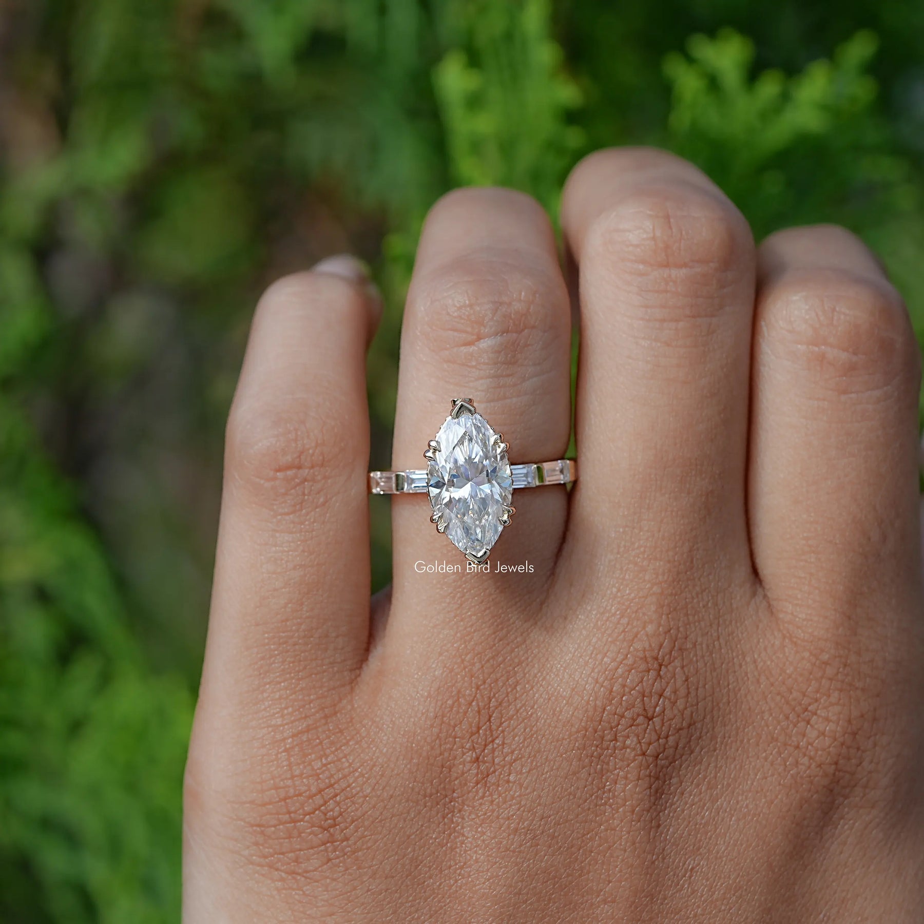In finger front view of  Marquise And Baguette Cut Moissanite Solitaire Accent Ring 