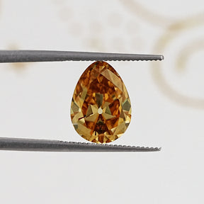 In Tweezer View Of Old Mine Pear Cut Loose Moissanite Stone