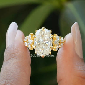 Front View of Oval And Marquise Cut Moissanite Ring In two Fingers