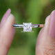 Front view of Princess Cut moissanite engagement ring holding in two fingers 