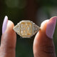Two fingers holding the Radiant Cut Moissanite Accent Stone Ring