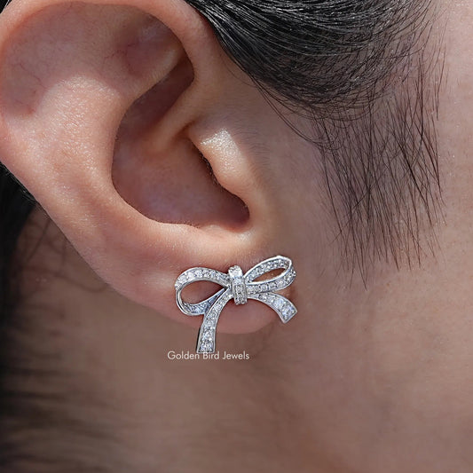 In Ear View Of Round Cut Lab Diamond Ribbon Bow Stud Earrings in prongs setting 