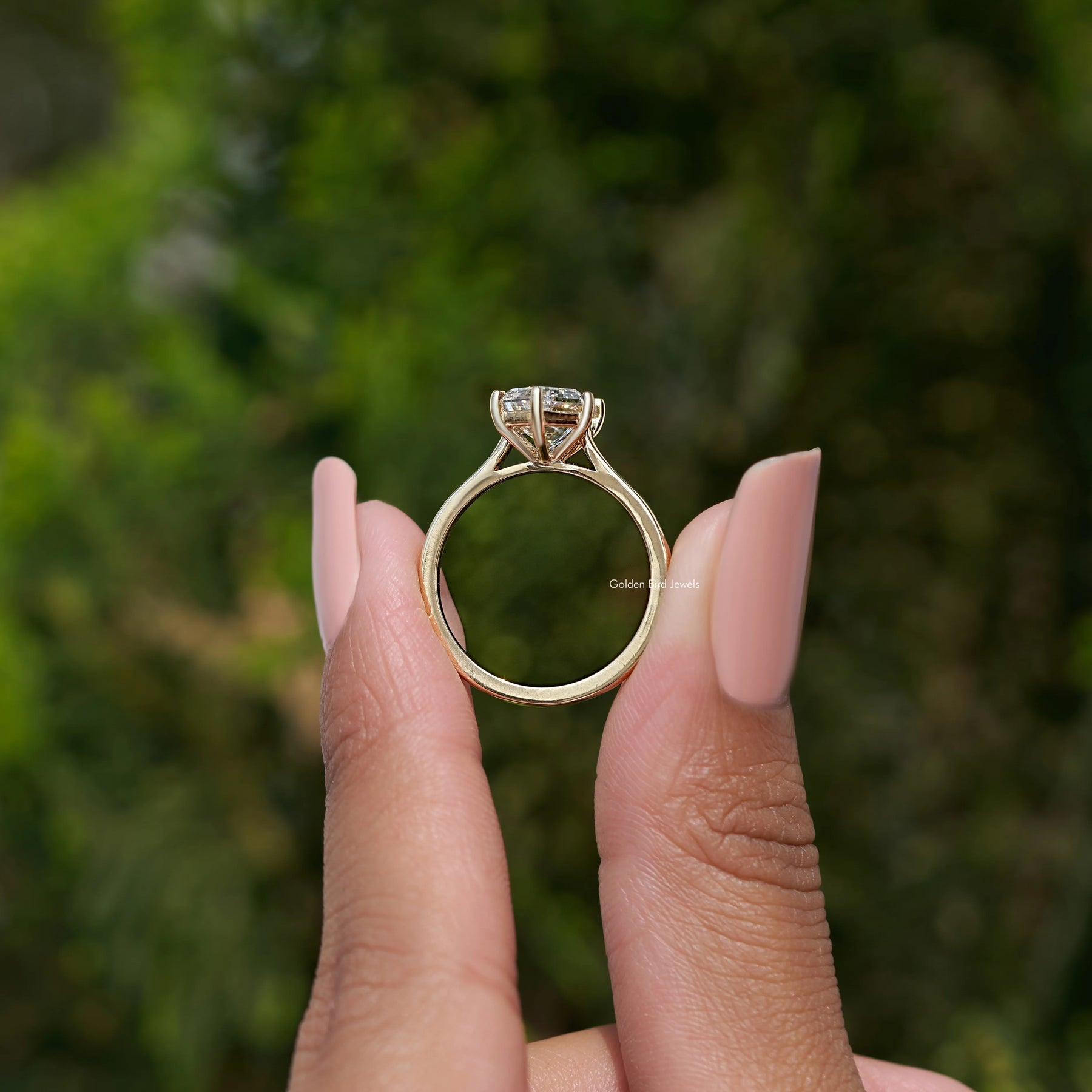 Back view A step cut Dutch marquise diamond ring in two fingers